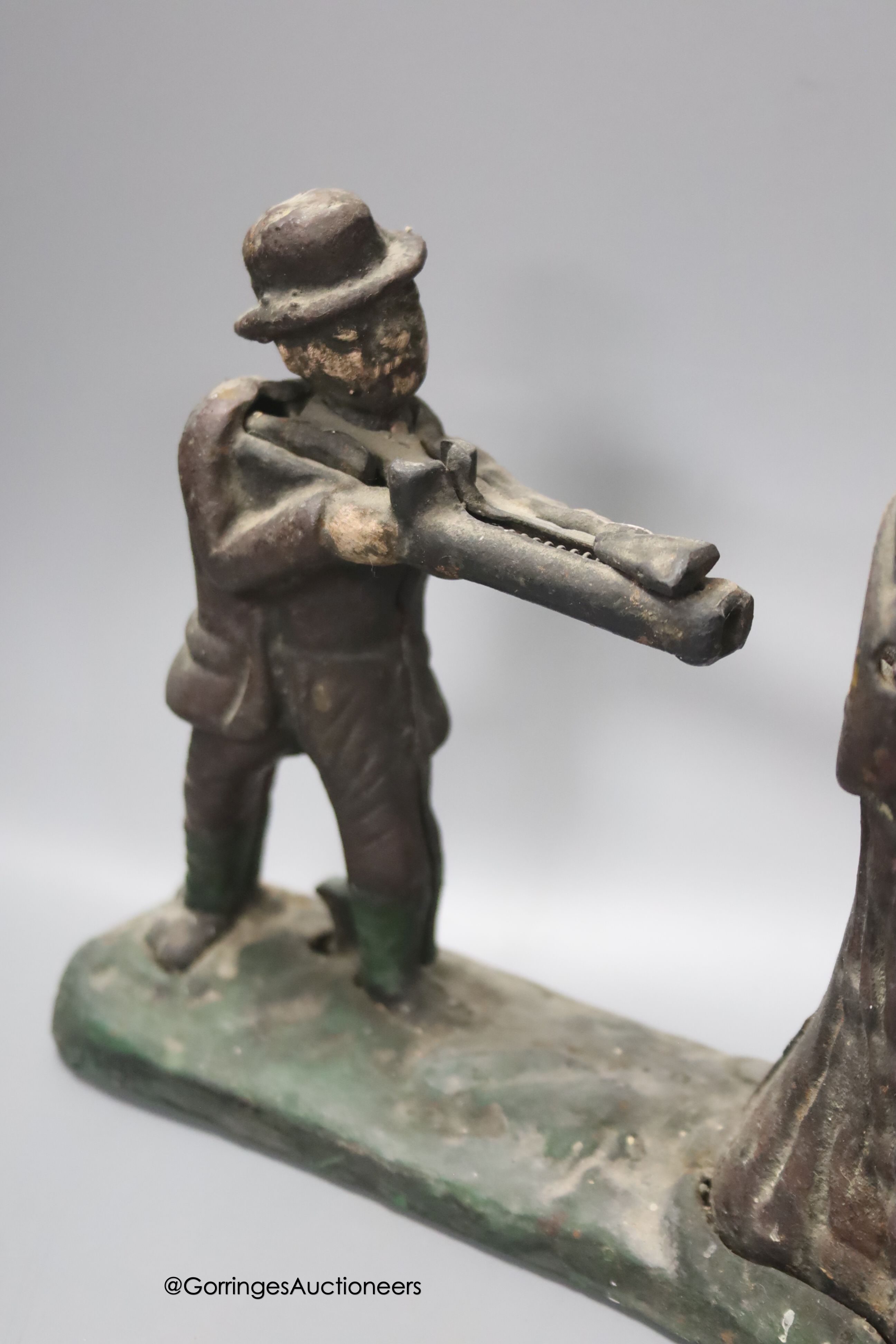 A cast iron Creedmore-type novely money bank, width 24cm, and a small copper horn, in leather case